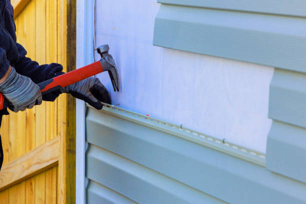 Worker Replacing vinyl siding on a residential house exterior